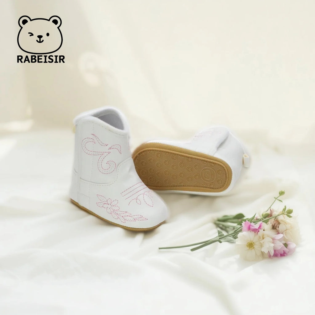 'Cowboy Kate' Anti-Slip Baby First Walker Boots showcased from the side, featuring cute pink flower stitching.
