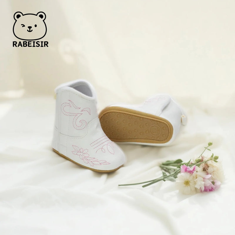 'Cowboy Kate' Anti-Slip Baby First Walker Boots showcased from the side, featuring cute pink flower stitching.