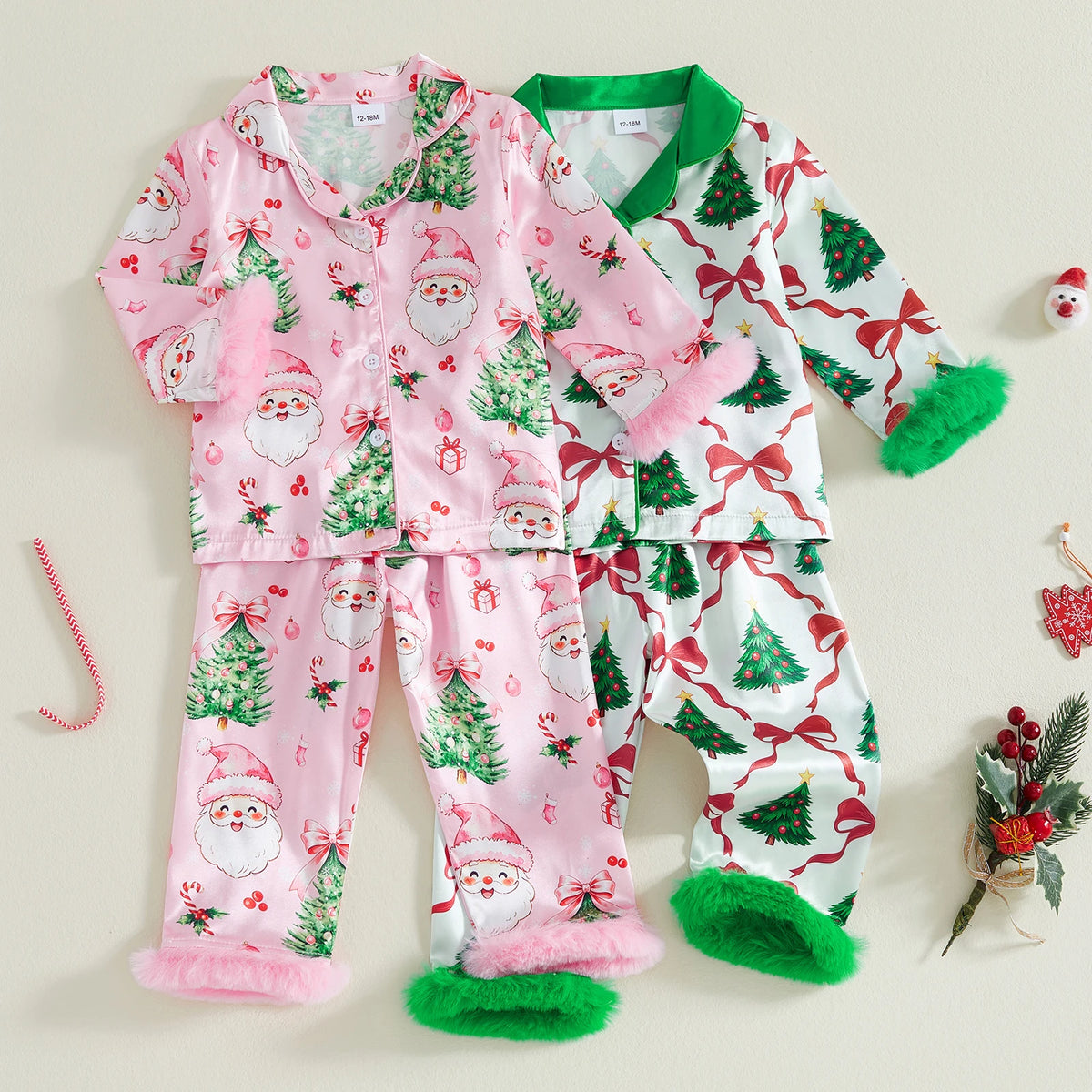 Girls Christmas pajama set with Santa and tree prints featuring pink fuzzy cuffs and green ribbon accents.