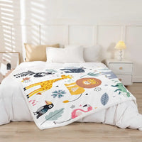 Jungle Rumble double-sided children's blanket with lion, giraffe, zebra, flamingo on a white bed.