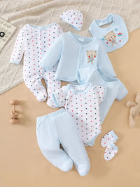 8-piece light-blue cotton baby layette set with teddy bear embroidery; includes bib, cap, mittens, romper, and pants