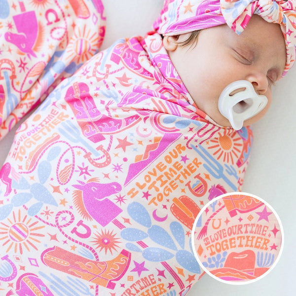 The Forever Large Swaddle Blanket in Saddle Up Western theme, perfect for wrapping your baby in comfort.