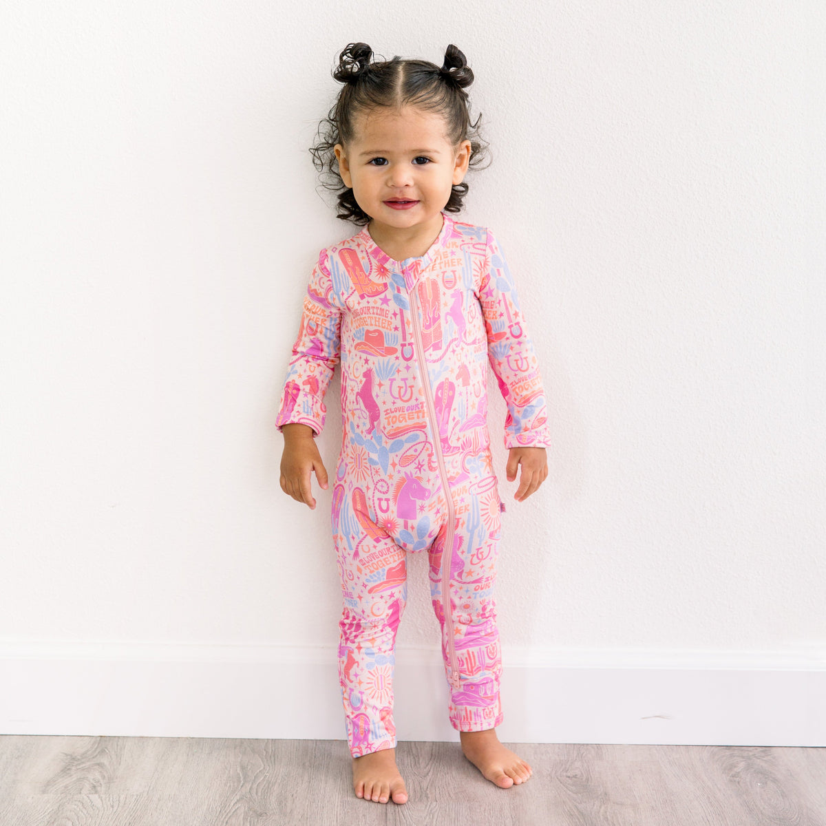 Baby wearing the Second-Skin Footless Romper | Saddle Up Western Themed enjoying playful moments, a cozy bamboo baby romper perfect for little explorers.