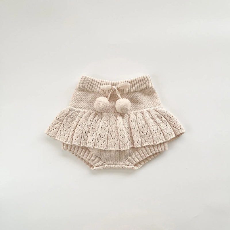 Sweet image of the beige Popcorn Knit Pullover with cute toddler skorts, perfect for fashion-forward kids.