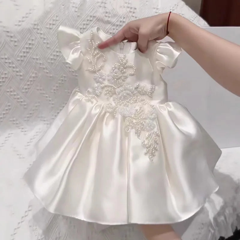 Astrid satin flutter-sleeve dress for little girls, white satin with beaded floral applique on bodice and full skirt.
