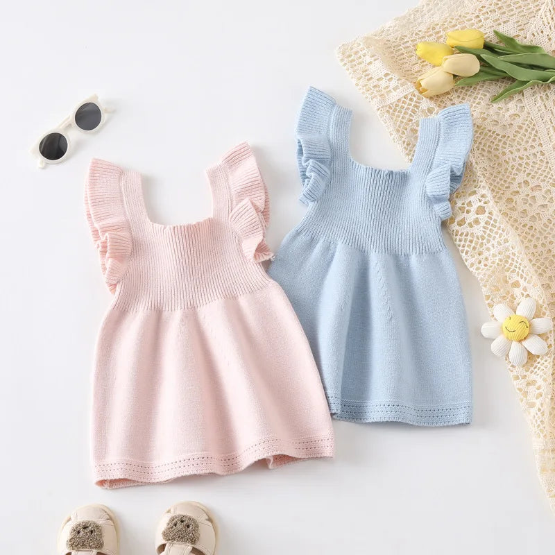 Brie Pastel Knit Dress Pinafore featuring adorable ruffles, available in pink and blue colors, perfect for every occasion. This pastel knit dress is comfortable and stylish.