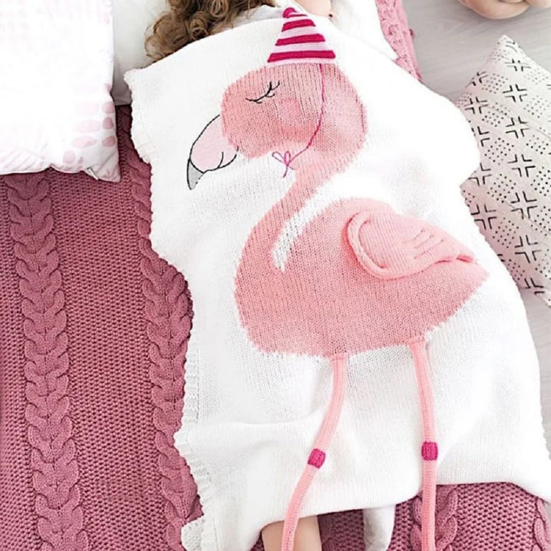 A cozy pink flamingo blanket draped over a bed, part of the 'Sleepy Tight' cute animal blankets for kids.