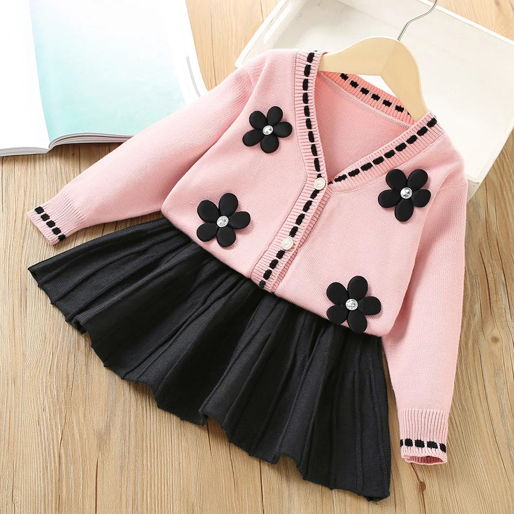 Vanessa Floral Knitted Cardigan and Pleated Skirt two-piece set: pink cardigan with black flower appliques.