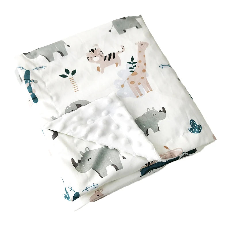Folded white minky baby blanket featuring safari animals like giraffes, tigers, and rhinos, with a soft dotted texture for toddlers.