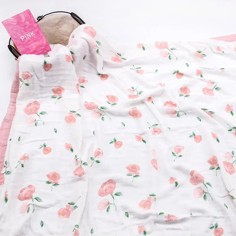 Two-layer bamboo cotton baby swaddle blanket with pink rose pattern and pink edging.