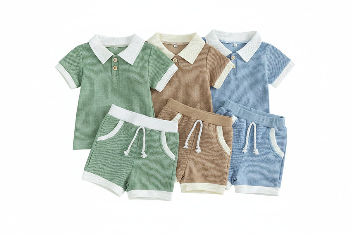 Three children's outfits in green, brown, and blue on a beige background