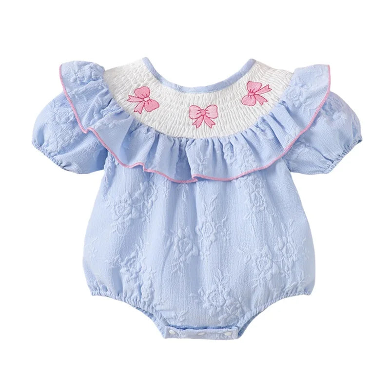 Three Little Bows & Frills Smocked Baby Dress in Boca Blue with pink bow embroidery and ruffle sleeves, perfect for baby girls.