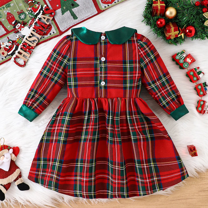 Louisa Girls Red Plaid Bow Dress displayed on a cozy white fur background, featuring a vibrant red plaid pattern with a charming Peter Pan collar and flared skirt.