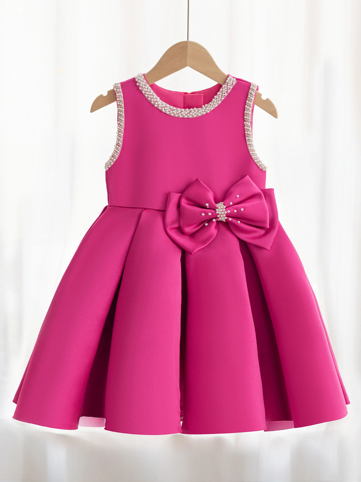 Taylor Elegant Beaded Formal Party Dress in pink for girls 2-7; knee-length, beaded neckline and pearl bow accent.