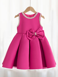 Taylor Elegant Beaded Formal Party Dress in pink for girls 2-7; knee-length, beaded neckline and pearl bow accent.