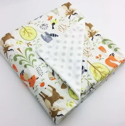 Cute woodland baby blanket featuring foxes and deer with soft white polka dot minky backing, 100x75cm.