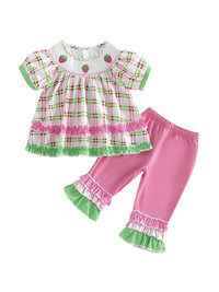 Frilly boho plaid two-piece set for little girls with embroidered strawberry accents on top and pink ruffle-trim pants
