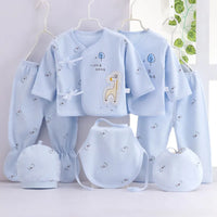 Playful giraffe-themed 7-piece newborn layette set in light blue with hat, bib, and booties