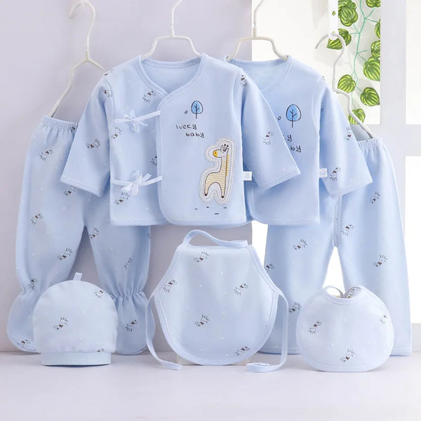 Playful giraffe-themed 7-piece newborn layette set in light blue with hat, bib, and booties