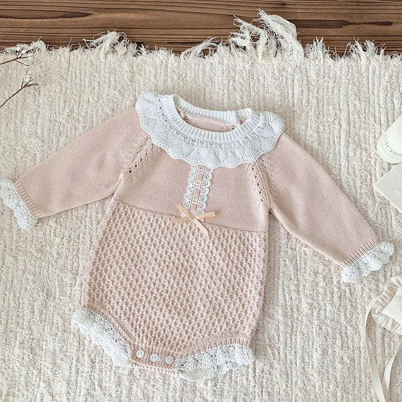 Close-up of the intricate crocheted accents on the Pretty In Knit Baby's Romper, showcasing its elegant design.