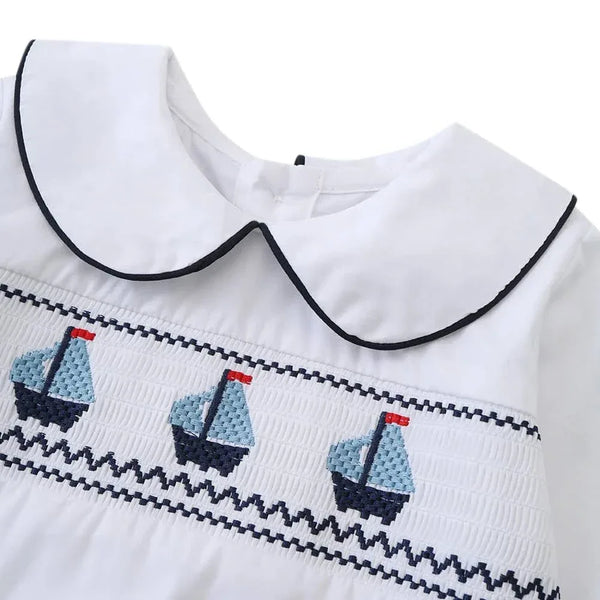 white toddler shirt with black trim collar and embroidered blue sailboat design nautical toddler outfit