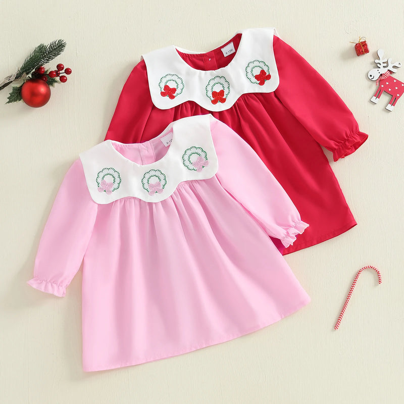 Three Little Wreaths Bibbed Baby A-Line Dress featuring red and pink color options, perfect for holiday events.