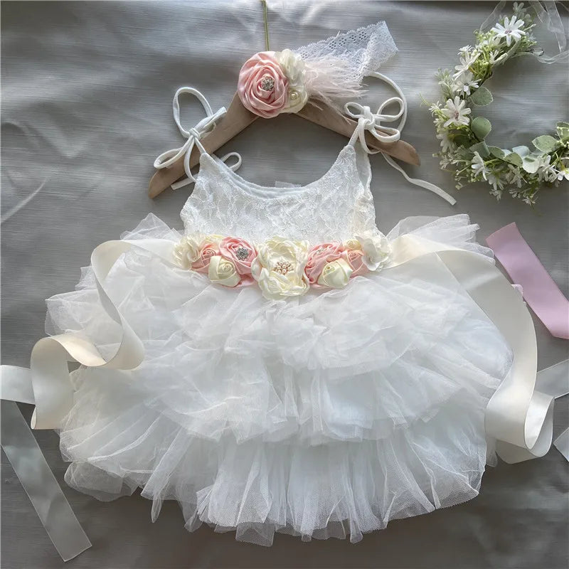 Cecilia vintage tiered white tulle dress with floral belt and matching headband, lace bodice and rose accents.