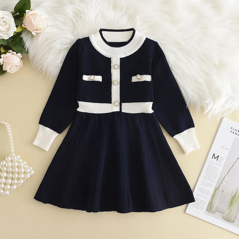 Chic Melinda Knit Dress in elegant navy blue with button accents and flared silhouette, suitable for special events.
