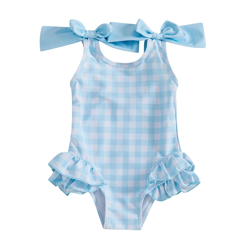 Cute In Checks cute swimsuit for kids styled in light blue gingham with ruffle details and shoulder bows.