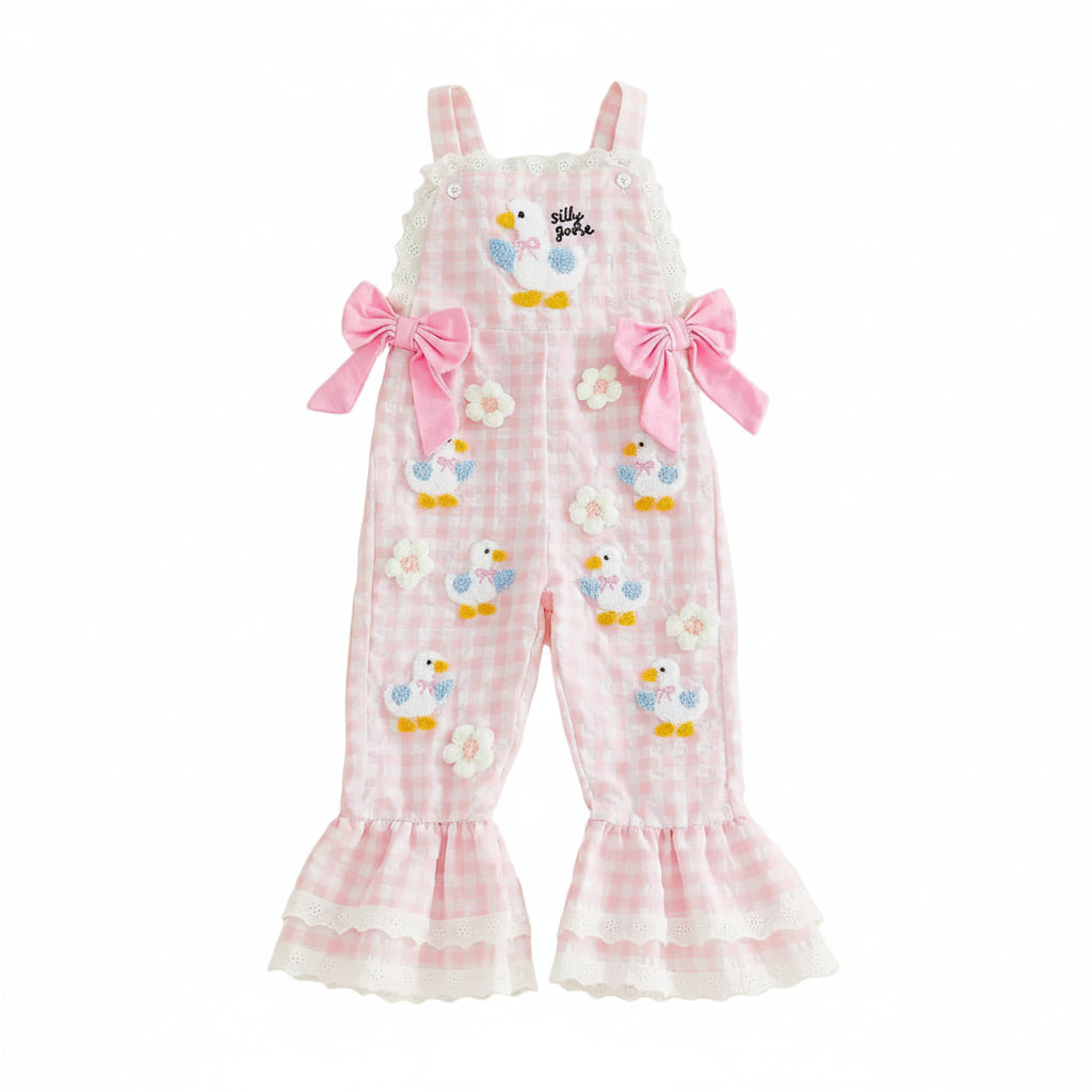 Pink checkered romper with bird designs on a beige background