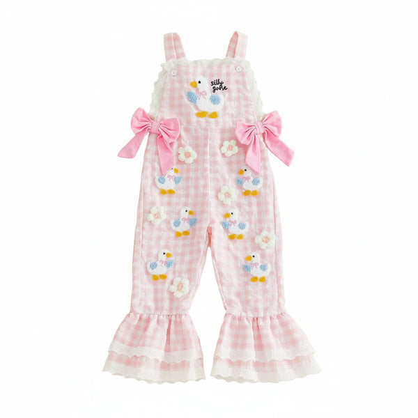 Pink checkered romper with bird designs on a beige background