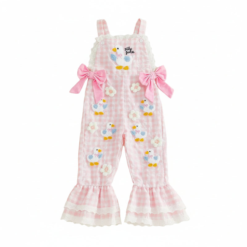 Pink checkered romper with bird designs on a beige background