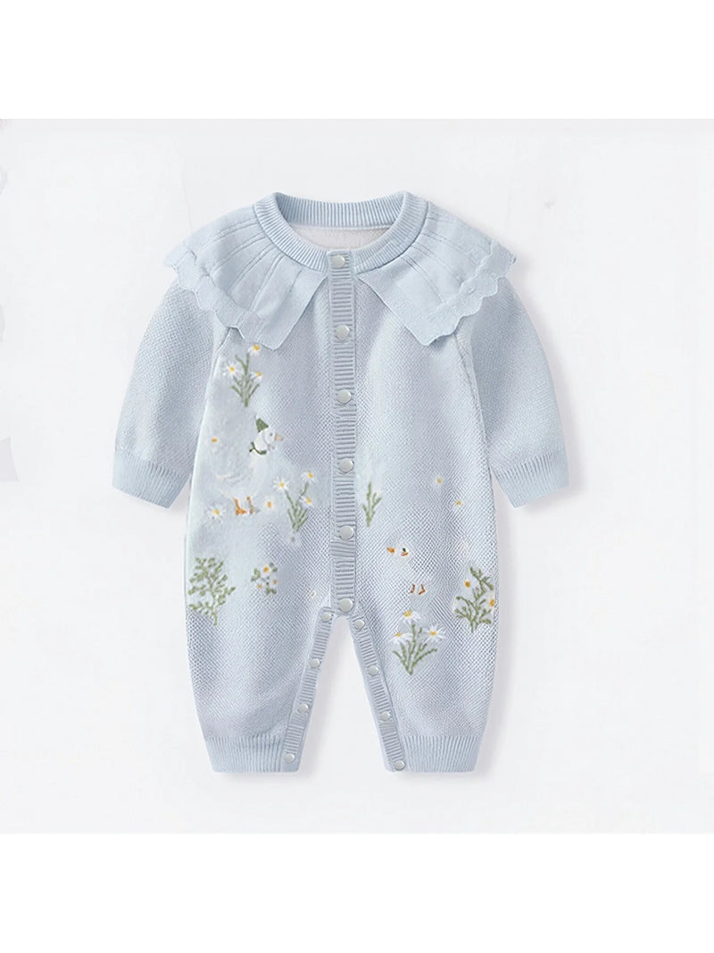 Boca Blue Fleurs Knit Long Sleeve Baby Romper showcasing a soft and breathable fabric, designed with a frilly trim and button closures for easy dressing, ideal for special occasions or everyday wear.