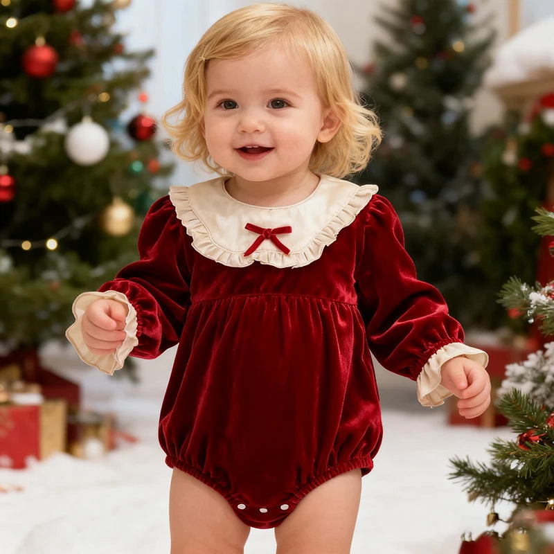 Adorable toddler in a festive 'Frilly Crissy' Winter Velvet Bubble, featuring a red plush fabric and a lace collar, perfect for holiday outings. Ideal baby bubble romper for winter celebrations.