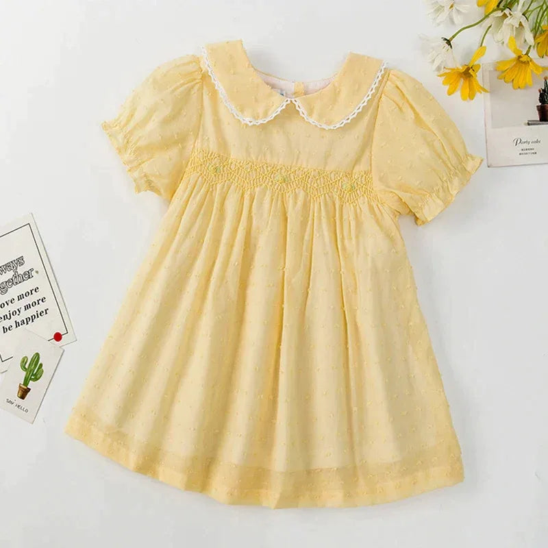 Yellow babies smocked party dress with puff sleeves and white lace collar for infants