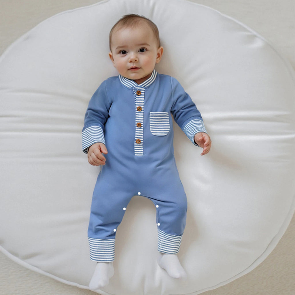 Hudson Button-Down Stripe Romper in blue worn by a baby seated on a soft cushion, showcasing a comfortable fit and stylish design.