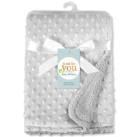 Gray dotted baby blanket with white ribbon and tag, soft polyester swaddle, 100x70 cm, unisex.