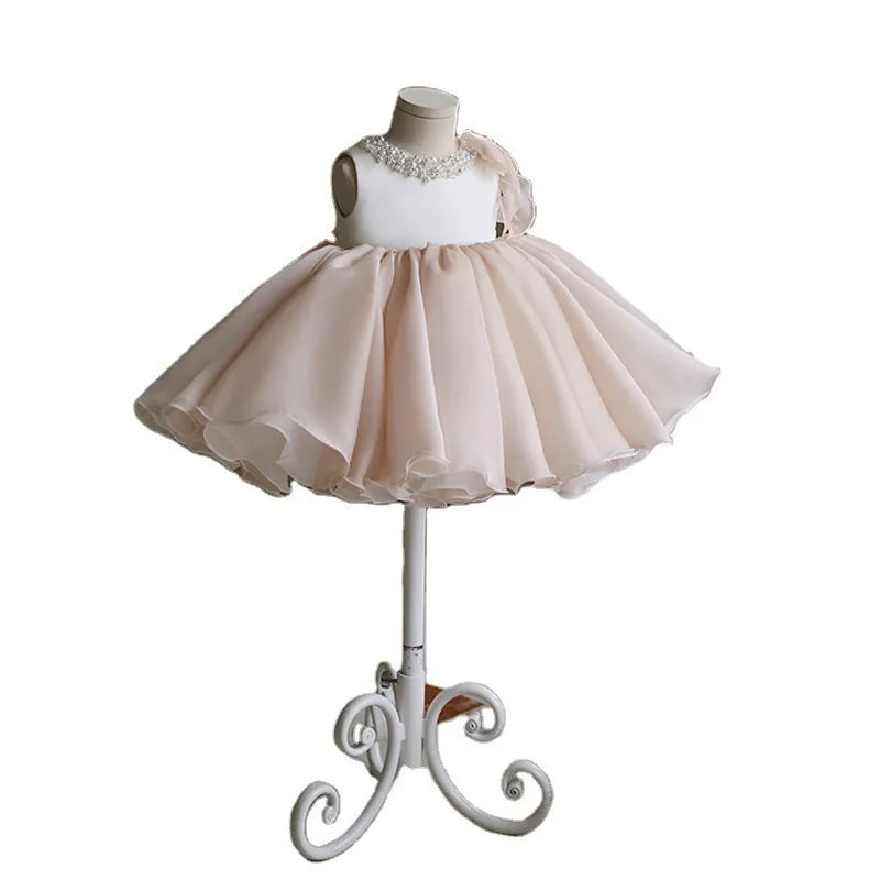 Gwendolyn Tulle Special Occasion Dress in chic beige displayed on a mannequin, featuring a flattering round neckline, fitted bodice embellished with embroidered bead accents, and an airy flared layered tulle skirt for children aged 4 to 6.