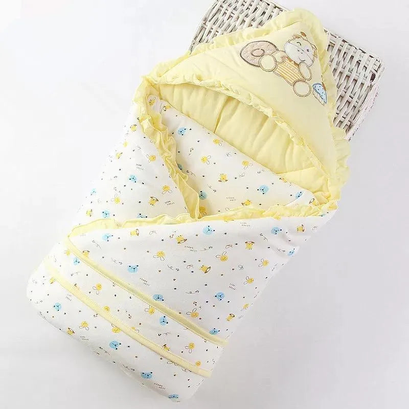 Soft and cozy 'Animal Cutie' baby swaddle wrap in sunny yellow with adorable animal motifs, perfect for infants up to 12 months.