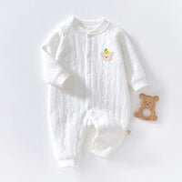 White quilted baby romper with long sleeves and bear patch, featuring front snaps for warmth and a wooden bear teether.
