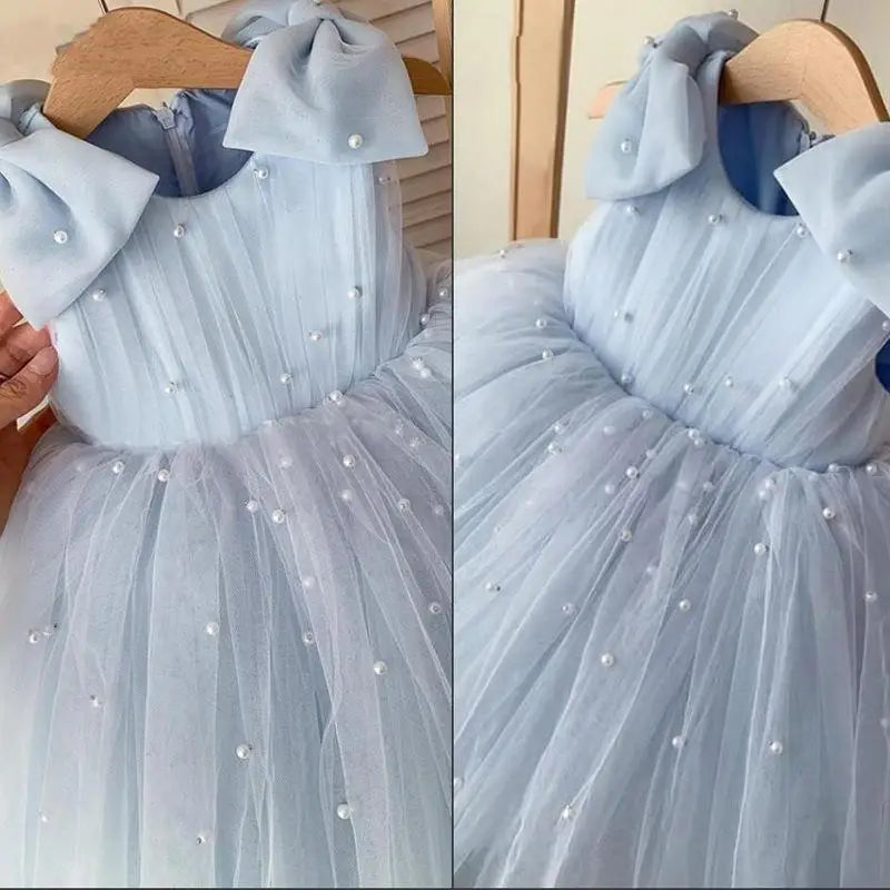 Light blue Daria Tulle and Faux Pearls Party Dress with pearl beads, shoulder bows, and a tulle skirt.