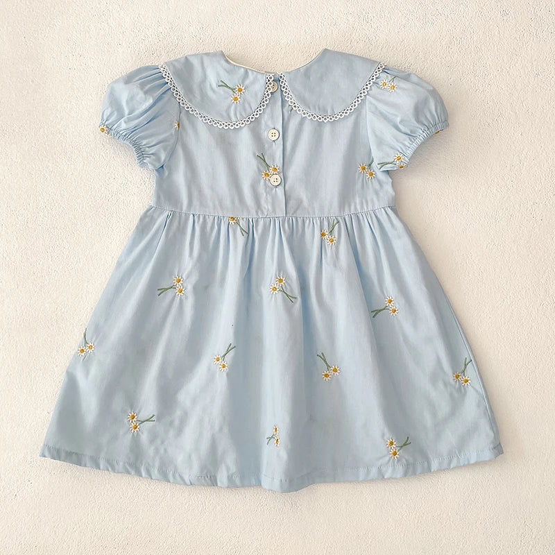 Back view of the Sweet Lydia Little Girl's Dress in sky blue showing buttons and beautiful embroidery, ideal for ages 2 to 6.