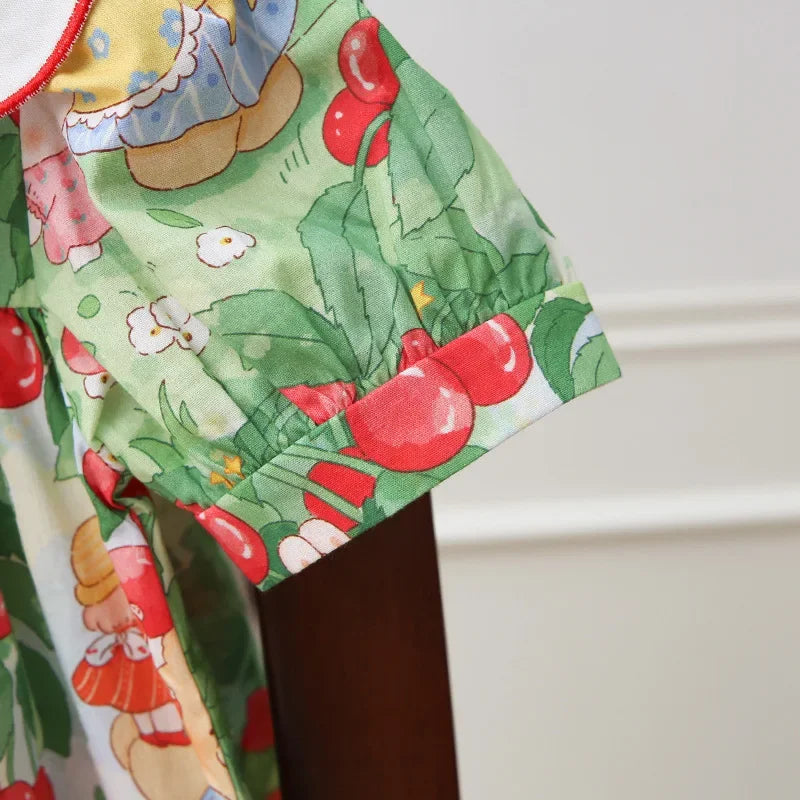 Detailed view of the sleeve hem of A Very Cherry Day Embroidered Dress, featuring the cute cherry print dress pattern with fun illustrations.