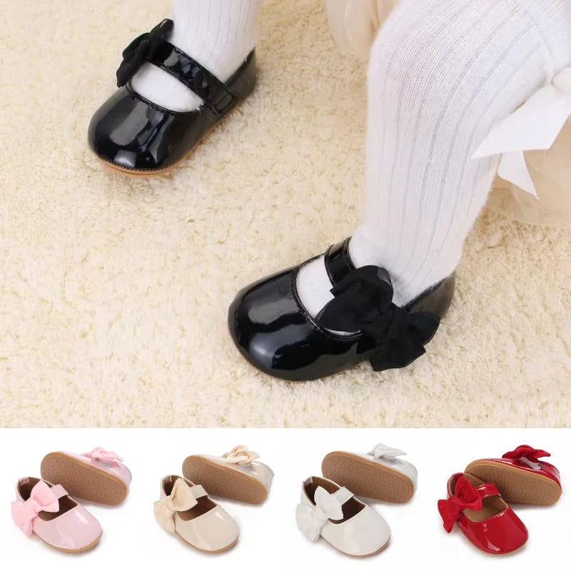 Collection of 'Serena' Bow First Walker Shoes in various colors including pink, black, beige, and red, showcasing adorable designs perfect for toddlers.
