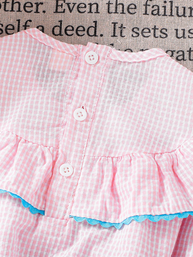 Detail of the ruffled back and button closure on the Birthday Girl Romper, crafted in lightweight cotton for babies and toddlers.