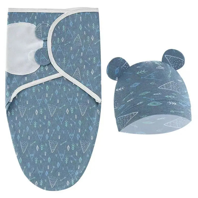 Soothing Baby Swaddle Set Cartoon for Newborns showcasing a blue swaddle wrap adorned with whale patterns and a matching hat.