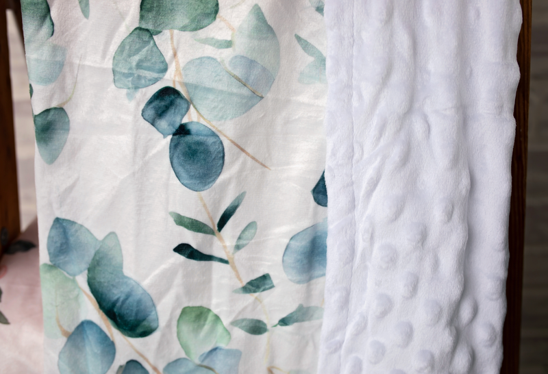 Stylish and hypoallergenic Eucalyptus Embrace Minky Blanket by Growing Sprouts, ideal for snuggling or as a decorative throw.