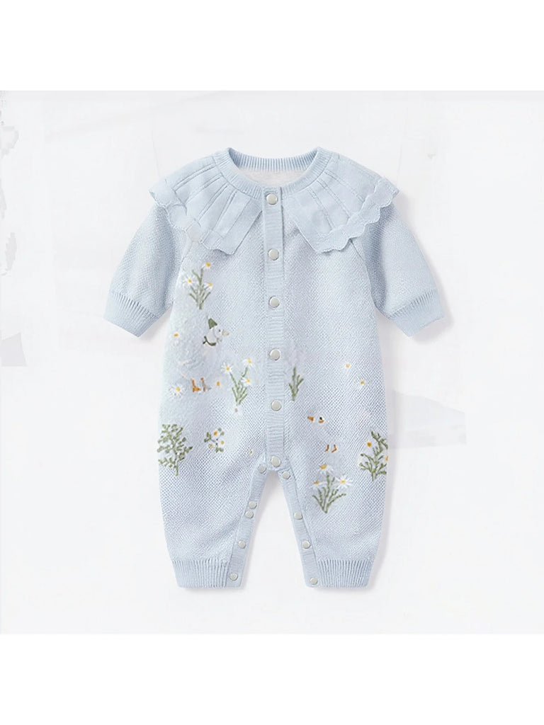 Boca Blue Fleurs Knit Long Sleeve Baby Romper featuring a delicate round neckline with a ruffled collar, vibrant Boca blue color, and charming flower embroidery, perfect for baby girls.