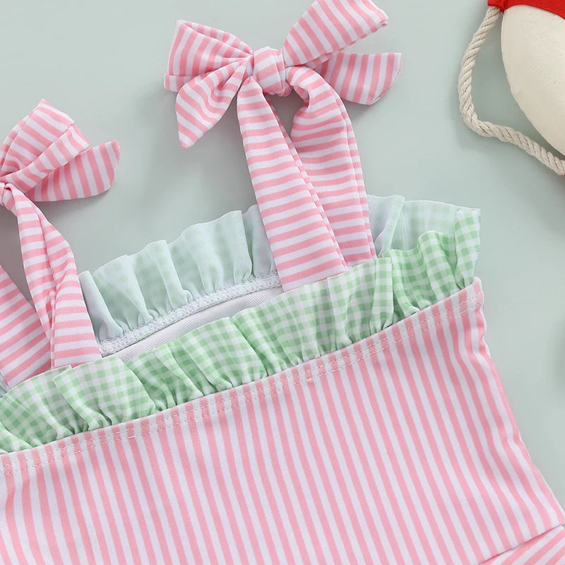 Close-up view of the straps and ruffled design of the 'Watermelon Baby' Cute One Piece Swimsuit, showcasing pink and white stripes with green accents.