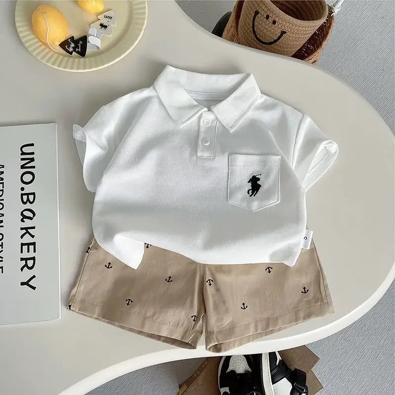 The Preppy 'Daron' 2 PC Kids Khaki Shorts Set displayed with both navy and white polo shirts and khaki shorts, perfect for casual adventures.